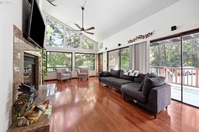 living room with ceiling fan, high vaulted ceiling, and hardwood / wood-style flooring