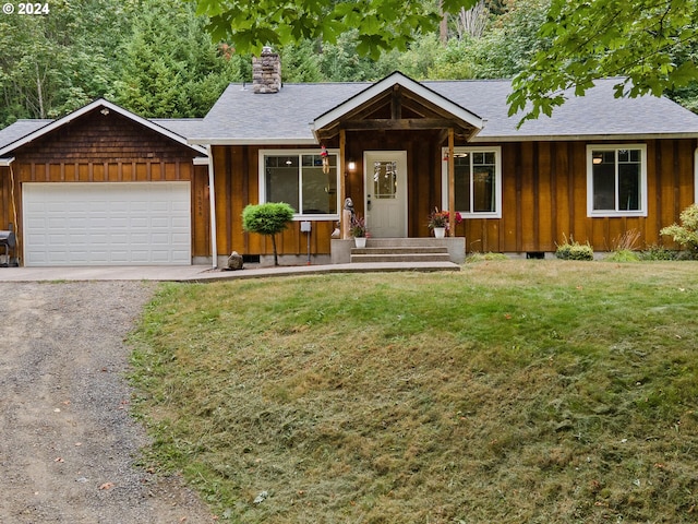 single story home featuring a garage and a front lawn