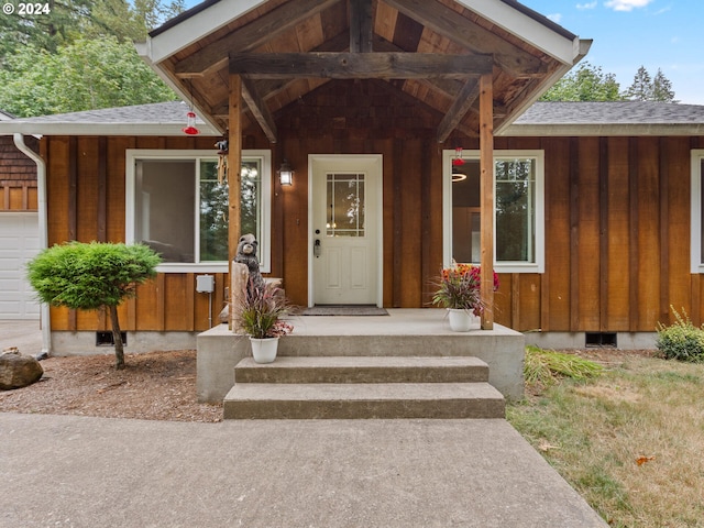 view of exterior entry with a garage