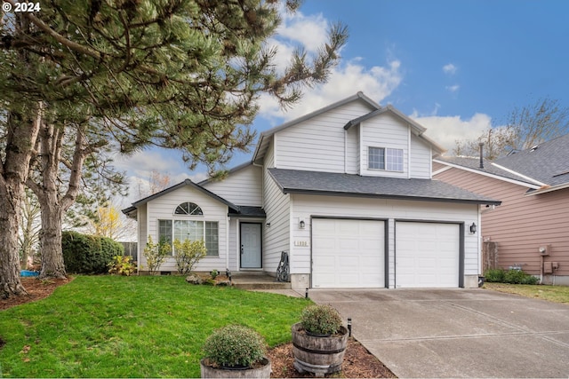 view of property featuring a front yard and a garage