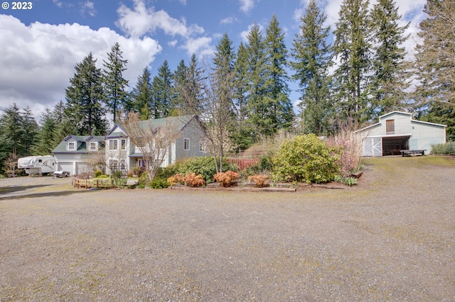 view of front of home with a garage and an outdoor structure