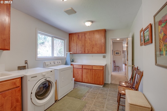 laundry room with cabinets and separate washer and dryer