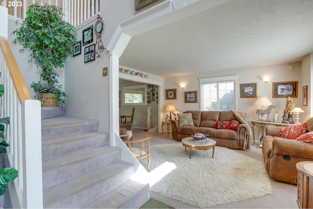 carpeted living room with a textured ceiling