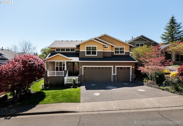 view of front of property with a garage and a front lawn