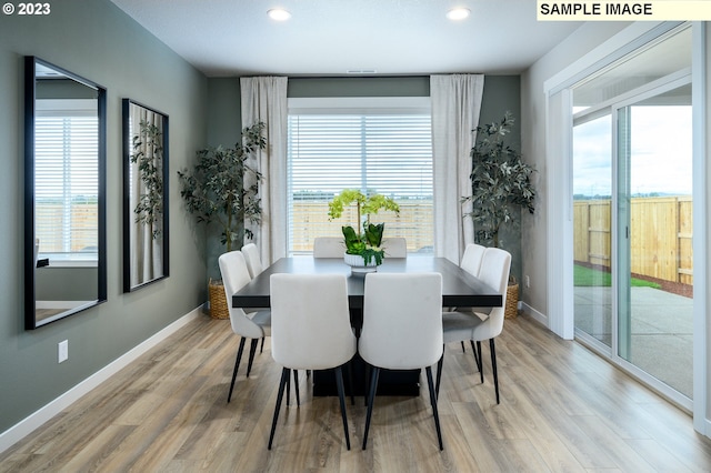 dining space featuring light wood-type flooring and a wealth of natural light