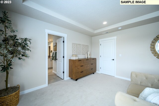 carpeted bedroom with a textured ceiling and multiple windows