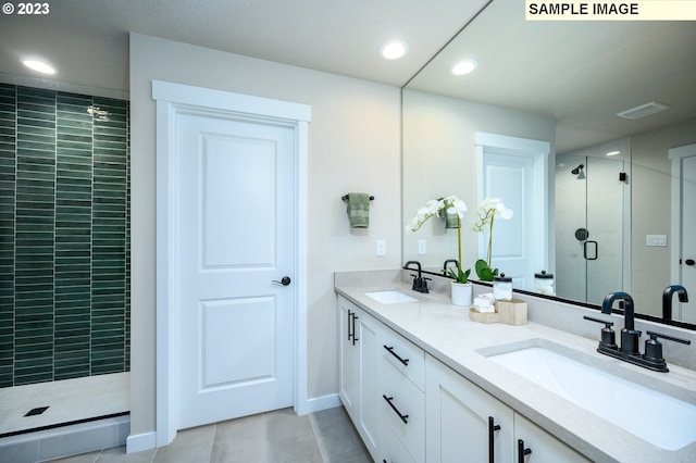 bathroom featuring tile patterned flooring, vanity, and walk in shower