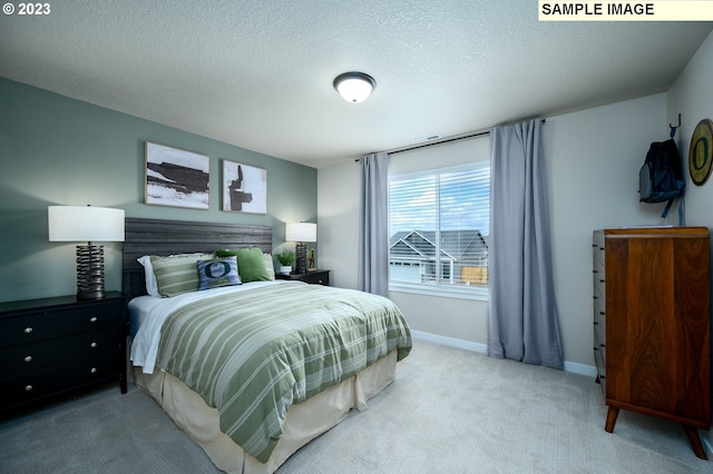 carpeted bedroom with a textured ceiling