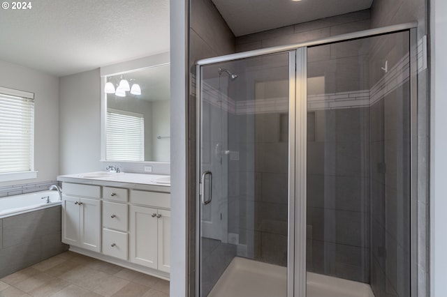 full bathroom featuring tile patterned flooring, a sink, a bath, double vanity, and a stall shower