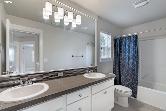 full bathroom with vanity, backsplash, tile patterned flooring, shower / bathtub combination with curtain, and a textured ceiling