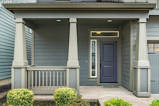 view of exterior entry with covered porch