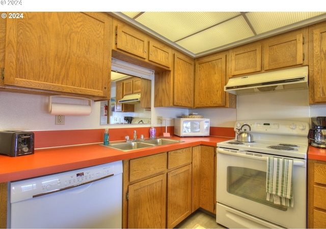 kitchen featuring white appliances and sink