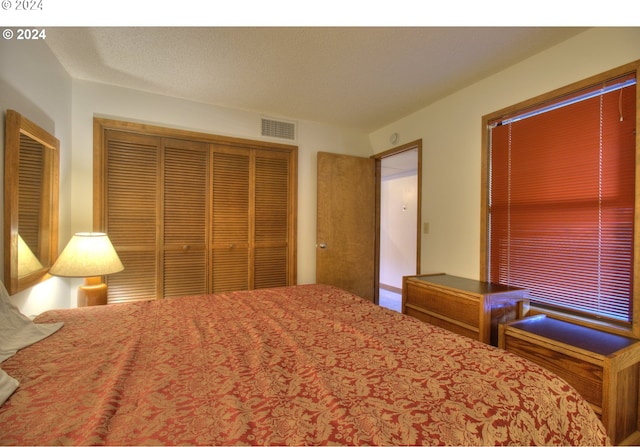 unfurnished bedroom with a textured ceiling and a closet