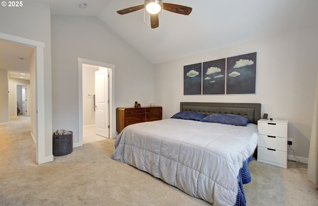 carpeted bedroom with ceiling fan, vaulted ceiling, and ensuite bath