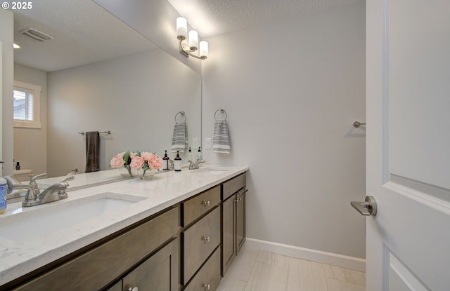 bathroom featuring vanity and a textured ceiling