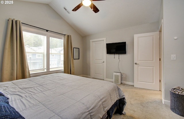 bedroom with vaulted ceiling, carpet flooring, a ceiling fan, baseboards, and visible vents