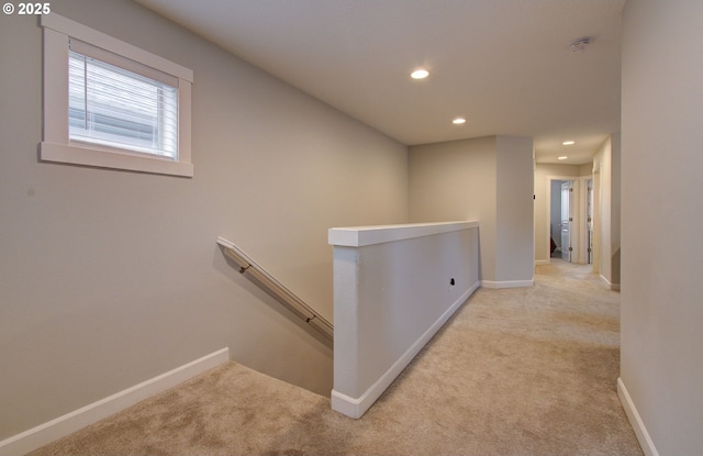 corridor with carpet floors, an upstairs landing, baseboards, and recessed lighting