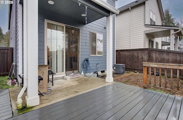 wooden terrace with cooling unit and fence