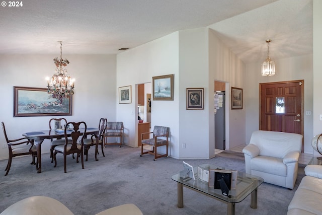 living room with a notable chandelier, light colored carpet, a textured ceiling, and a high ceiling