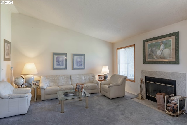 living room featuring lofted ceiling, a tiled fireplace, and carpet floors