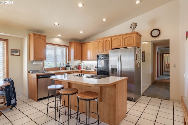 kitchen featuring vaulted ceiling, a kitchen island, sink, light tile patterned floors, and black appliances