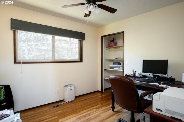 office area featuring ceiling fan, light hardwood / wood-style floors, and a textured ceiling