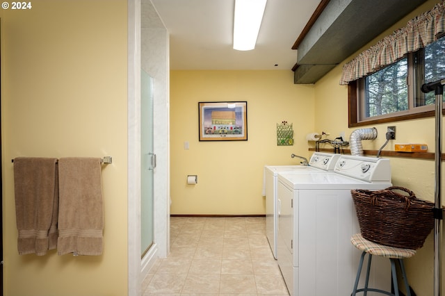 laundry area featuring washer and dryer and light tile patterned flooring