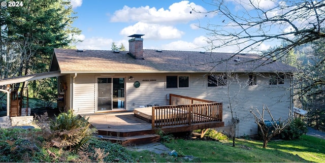 back of property featuring a lawn and a wooden deck