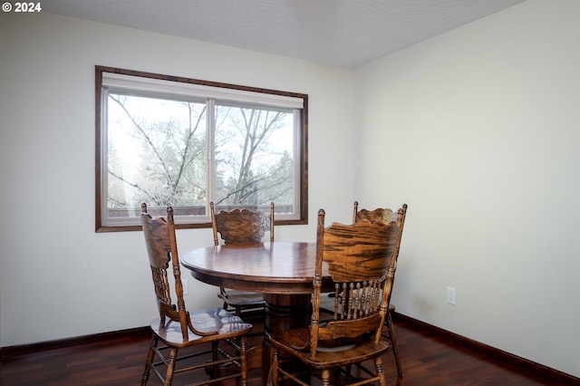 dining area with dark hardwood / wood-style flooring and a wealth of natural light