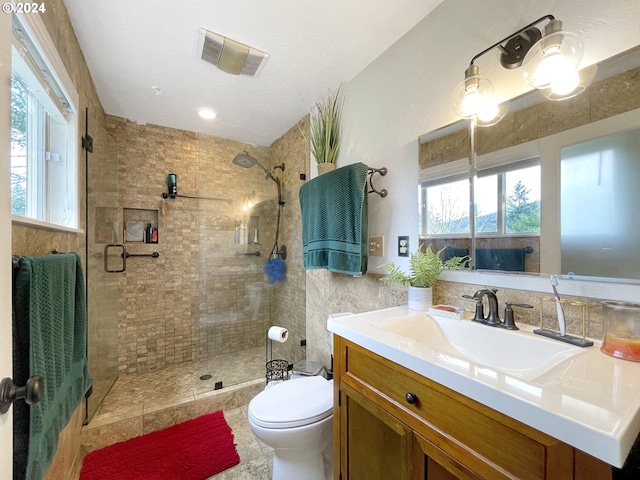 bathroom with vanity, a shower with shower door, and toilet