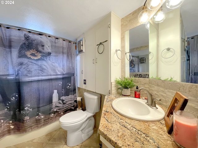 bathroom with tasteful backsplash, tile patterned floors, vanity, tile walls, and toilet