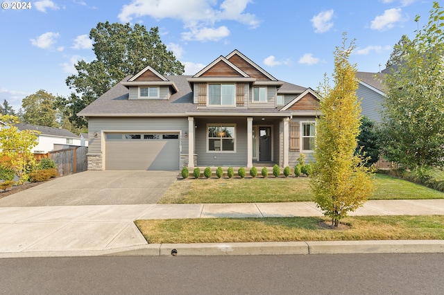 craftsman-style house with a garage and a front lawn