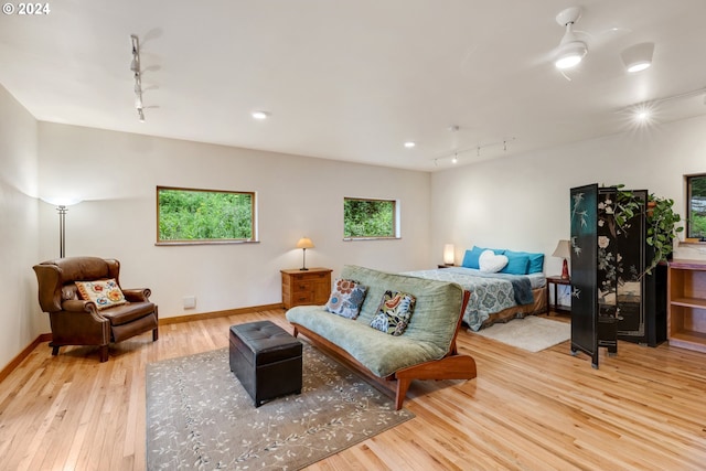 bedroom with light wood-type flooring and rail lighting