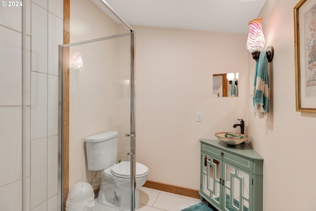 bathroom featuring tile patterned floors, a shower with door, vanity, and toilet