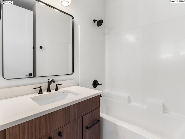 bathroom featuring shower / tub combination and vanity