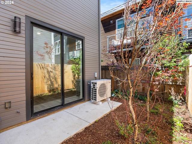 property entrance with ac unit and a patio