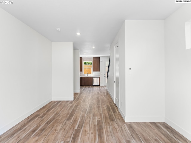 hall featuring light hardwood / wood-style flooring and sink