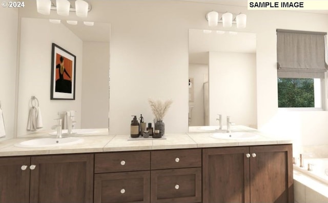 bathroom with vanity and tiled bath