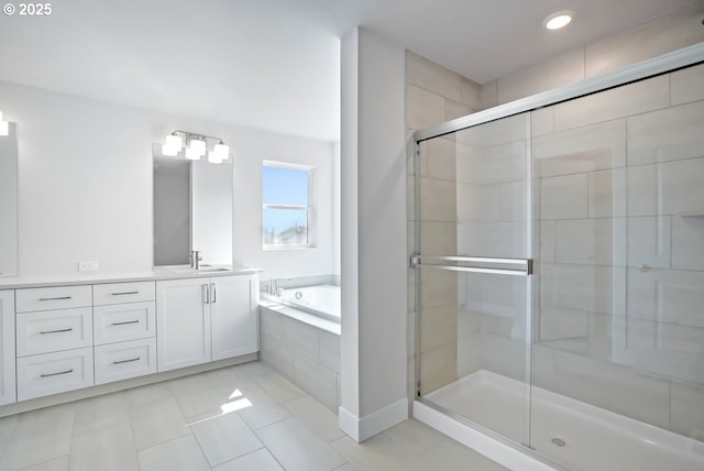 bathroom featuring recessed lighting, tile patterned floors, vanity, a bath, and a stall shower