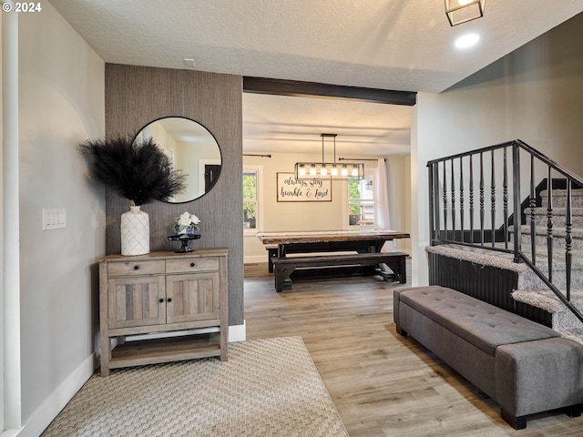 entryway featuring a chandelier, a textured ceiling, and light hardwood / wood-style floors