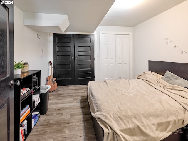 bedroom featuring a closet and light hardwood / wood-style flooring