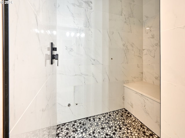 bathroom with a tile shower