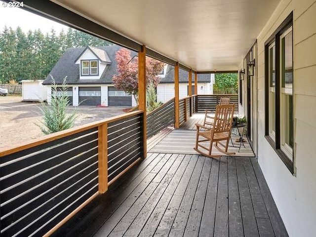 wooden terrace featuring a garage