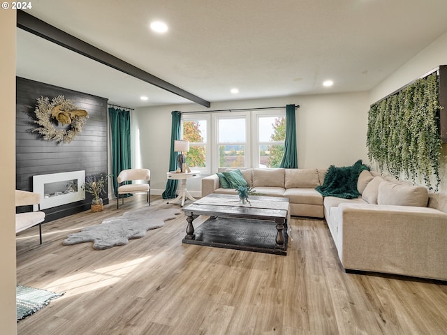 living room featuring a large fireplace and light hardwood / wood-style flooring