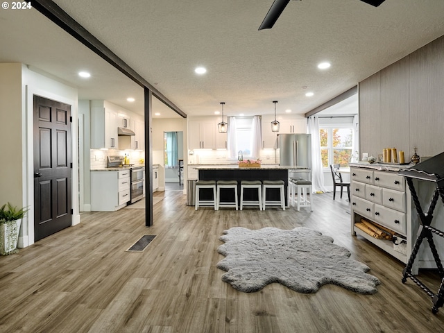 interior space with wood-type flooring and a textured ceiling