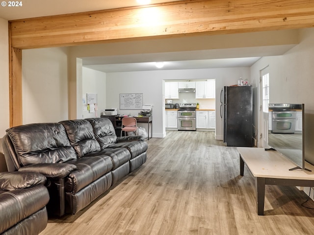 living room featuring light wood-type flooring and beamed ceiling