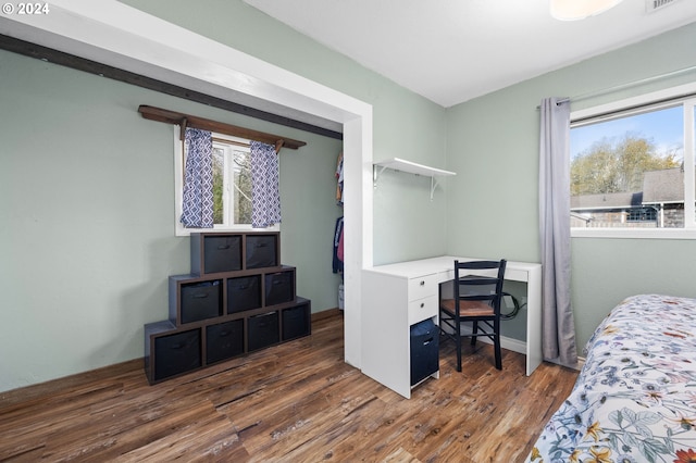 bedroom with dark hardwood / wood-style floors