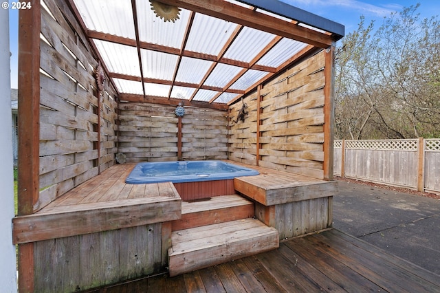 wooden deck featuring a hot tub