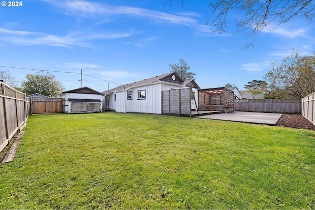 view of yard featuring a patio area and a storage unit