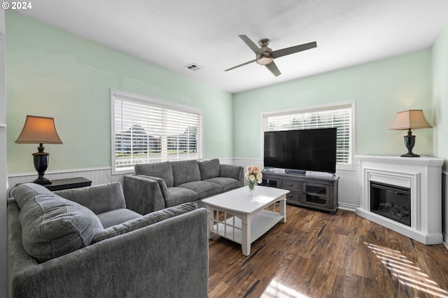 living room featuring ceiling fan and dark hardwood / wood-style flooring